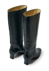 �Črni usnjeni škornji do kolen z gladkim zaključkom, ostrim prstom in majhnim kvadratnim petam. Notranjost obložena z bež materialom.