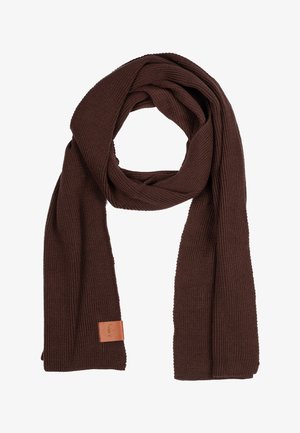 Dzianinowy brązowy szalik o teksturowanym splocie i skórzanej metce. Długi, prostokątny kształt zaprojektowany w celu zapewnienia ciepła i wszechstronności.