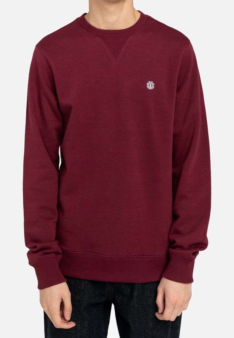 Bordowa bluza crewneck z prążkowanym dekoltem i mankietami, z małym logo na piersi, wykonana z miękkiej tkaniny bawełnianej.