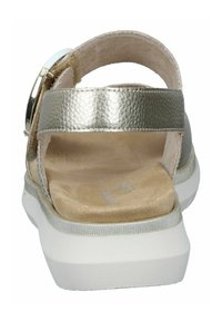 Silver metallic sandals with a back strap, suede insole, and white platform sole. Features a large decorative buckle on the side.
