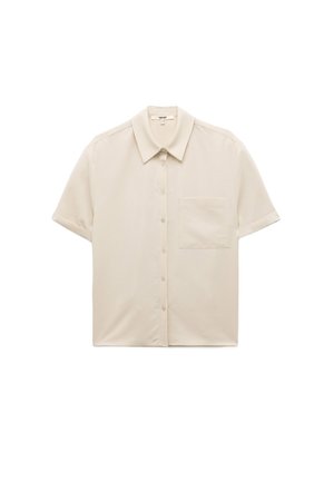 Kurzärmliges, knöpfbares Hemd aus hellbeigem Stoff. Mit klassischem Kragen und einer einzelnen linken Brusttasche. Glatte Textur.