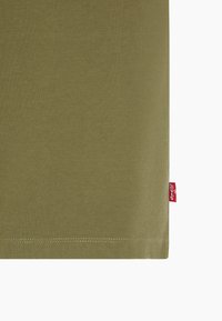 Olive green cotton t-shirt with a smooth texture, straight hem, and red brand label on the side. Simple, classic sleeve design.