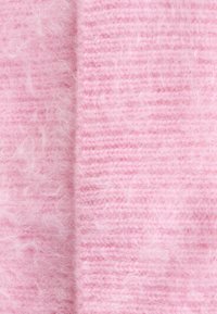 Soft, fluffy pink fabric with a textured, striped pattern. The material appears lightweight and fuzzy, enhancing its tactile quality.