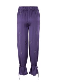 Purple satin pants with elastic waist, drawstrings at the cuffs, and decorative silver embroidery throughout. Smooth texture, relaxed fit.