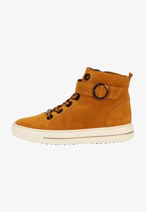 Tan suede high-top sneaker with a smooth texture, featuring lace-up front, side zipper, and a circular buckle detail on the strap.