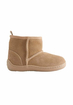 Light brown suede ankle boot with flat sole and visible stitching, designed for casual wear and comfort.