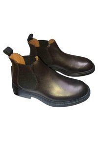 Stivali Chelsea in pelle marrone con pannelli elastici laterali, texture liscia, linguette di trasporto e design della punta arrotondata. Suola in gomma robusta.