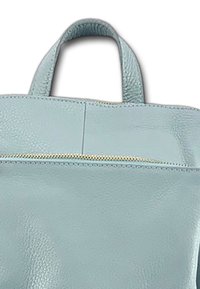  Lichtblauwe leren tote bag met een gestructureerde afwerking, voorzien van korte handvatten en een voorste ritszak met gouden hardware accenten.