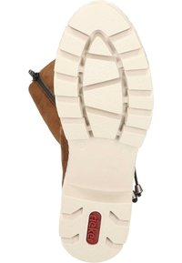 Brown suede boot with a white rubber sole featuring deep treads and a textured design. Includes a black zipper for easy wear.