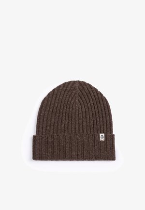 Brown ribbed knit beanie with folded cuff and small rectangular white logo tag on a white background.