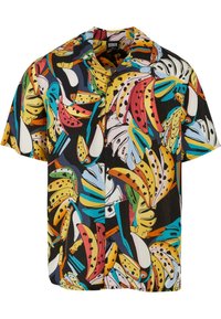 Chemise à manches courtes en tissu léger présentant un imprimé banane vibrant en jaune, rose, vert et bleu sur un fond noir. Boutons noirs.