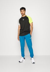 Ellesse OSTERIA - Calças de fato de treino - blue