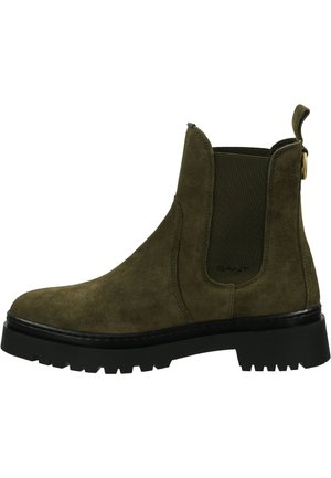 Green suede Chelsea boot with elastic side panels, a pull tab, and a chunky black rubber sole featuring treads for traction.
