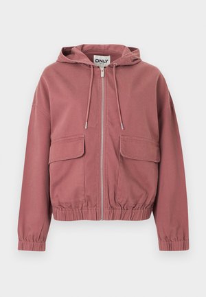 Sweat à capuche zippé couleur rose poussiéreux avec cordons de serrage, poignets et ourlet élastiqués, et deux grandes poches à rabat à l'avant, présenté sur fond blanc.