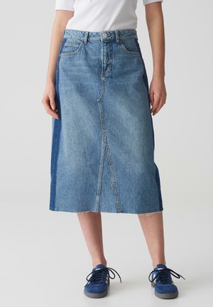 Jeansrock mit geradem Schnitt, hellblauer Farbe und sichtbaren Nähten. Mit abgeschnittenem Saum und seitlichen Einsätzen aus dunklerem Denim.