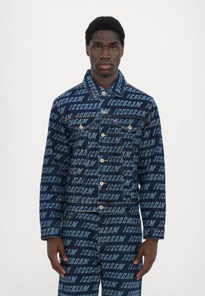 Denim jacket in dark blue with repeated "ICECREAM" text pattern. Features button front, collar, and chest pockets with white stitching accents.