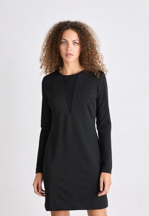 Black long-sleeve dress with a deep V-neckline, made from soft fabric. Smooth texture and tailored silhouette, knee-length design.