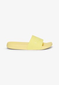 Yellow slide sandal made of soft rubber. Features a wide strap with embossed branding. Smooth texture and open-toe design.