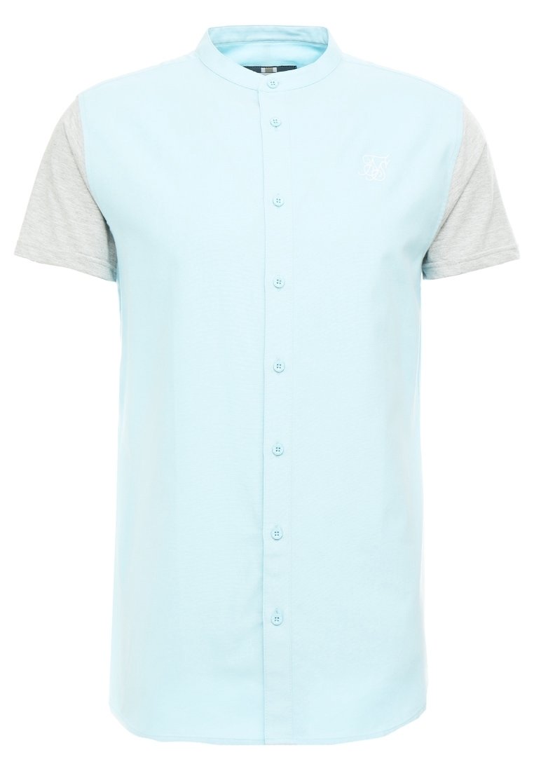 Kortärmad skjorta med ljusblå kropp och grå ärmar i tyg, med knäppning fram och en liten broderad logotyp.