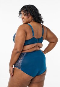 Teal bra and high-waisted underwear set. Soft fabric with lace accents in light purple along the sides. Adjustable straps and hook closure.