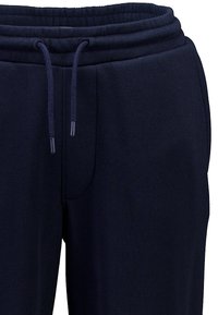 Dunkelblaue Jogginghosen mit einem Kordelzugbund, weichem Stoff, elastischem Bundabschluss und seitlichen Taschen.