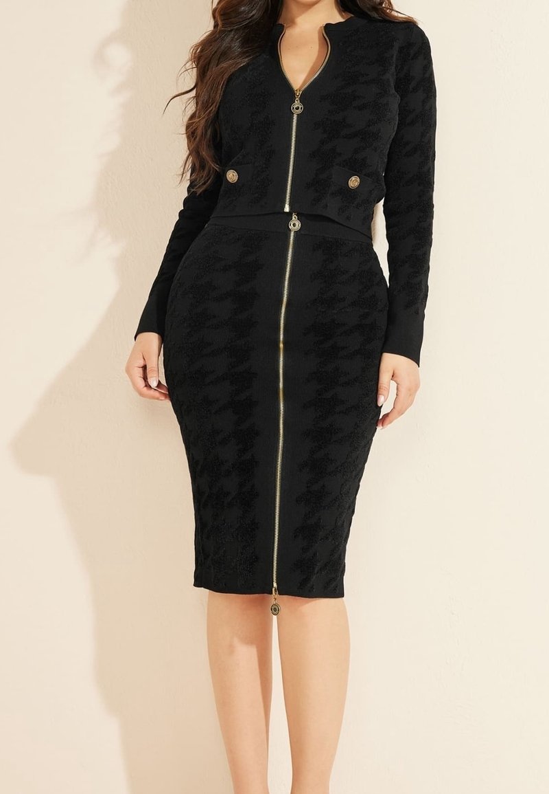 Black fitted dress with a textured houndstooth pattern. Features long sleeves, a zip front, and gold-toned hardware accents.