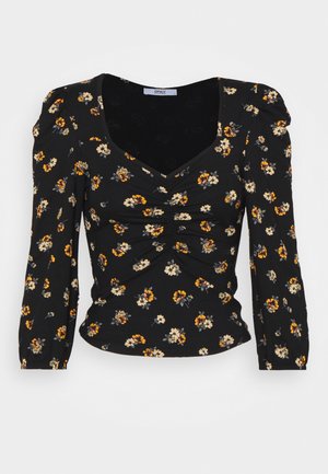 Μαύρο φλοράλ μπλουζάκι με μακριά μανίκια. Έχει μαζεμένα σχέδια εμπρός και τετράγωνη λαιμόκοψη. Φλοράλ σχέδιο με κίτρινες και λευκές λεπτομέρειες.