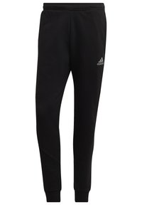 Svarta atletiska joggers gjorda av mjuk fleece med elastisk midja, smalnade ben och en liten silverlogotyp på sidan.