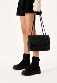 Kazar VIDIA - Cross body bag - black