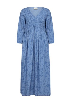 Blue maxi dress featuring a V-neck, long sleeves, and textured smocking detail at the bodice, with a subtle floral pattern throughout.