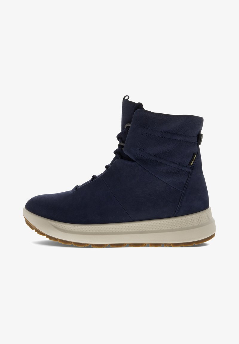 Navy blue high-top shoes made of textured leather with a cushioned cream sole, featuring a laced front and a padded collar for support.
