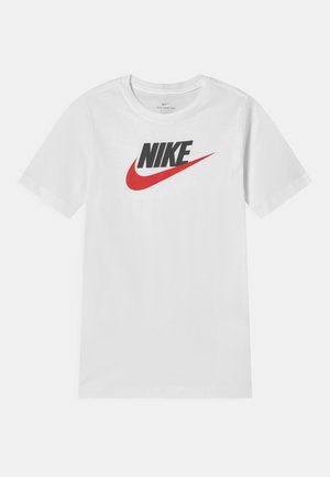 Camiseta blanca de manga corta hecha de algodón con cuello redondo. Presenta un logotipo negro de "NIKE" y un gráfico de swoosh rojo en la parte frontal.