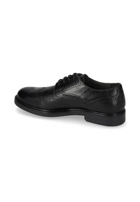 Scarpa di pelle nera con design wingtip, caratterizzata da dettagli brogue, punta tonda e suola piatta. I lacci e la finitura liscia sono visibili.
