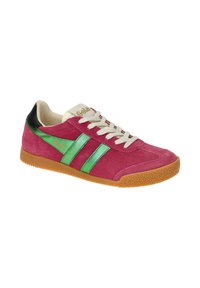Pink suede sneaker with green and black accents. Features a textured brown rubber sole and beige laces. Logo displayed on the tongue.