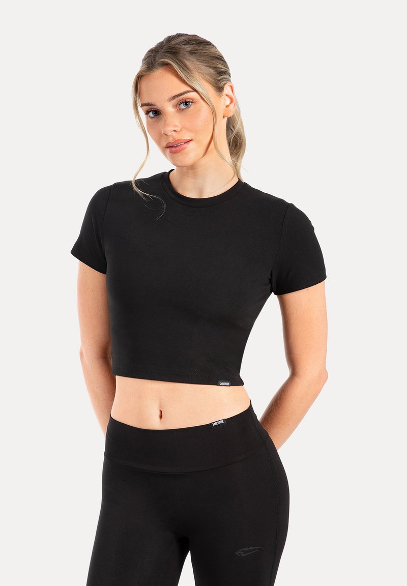 Czarny krótki t-shirt wykonany z gładkiego, elastycznego materiału, z okrągłym dekoltem i krótkimi rękawami. Posiada małe logo blisko dołu.