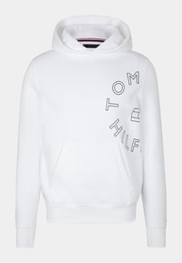 Witte hoodie van een katoenmix, met een voorzak en een ronde capuchon. Zwarte opdruk met de tekst "TOM HILFIGER" in een cirkelontwerp.