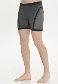 Svarta och grå mönstrade boxershorts med design som sitter nära kroppen, med en elastisk midjeband och texturerad tyg längs sidorna.