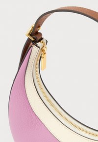 Small crescent-shaped handbag with pink and white leather panels, gold zipper and hardware, and a brown leather strap.