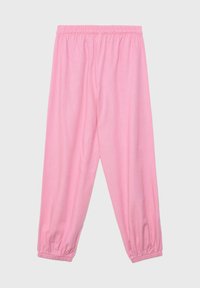 Pantalon de jogging rose clair avec taille et chevilles élastiques, coupe décontractée sans logos ni motifs visibles.