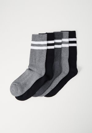 Four pairs of socks in black, dark gray, light gray, and heather gray, featuring ribbed cuffs and white striped accents.