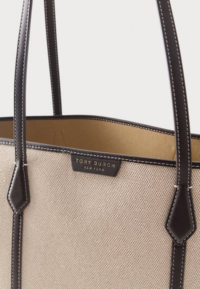 Μπεζ τσάντα tote με υφή, με λαβές και επένδυση από σκούρο καφέ δέρμα, που διαθέτει μια μικρή μαύρη ετικέτα με χρυσό κείμενο "Tory Burch New York".