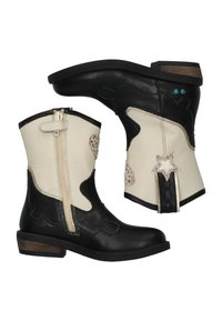 Zwarte en crèmekleurige leren cowboylaarzen met een ritssluiting, steraccenten en decoratieve stiksels. Korte schacht met een lage houten hak.