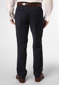 Navy dress pants with a straight-leg design, featuring a smooth texture and two back pockets. Worn with a brown leather belt and shoes.