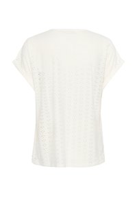 Haut court à manches courtes en tissu à œillets avec un motif texturé. Le design a une coupe décontractée et un col rond.