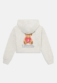 Haut de survêtement gris court avec un graphique d'ours tenant un cœur rouge étiqueté 'LA' et le texte 'Californie, États-Unis d'Amérique' en dessous.