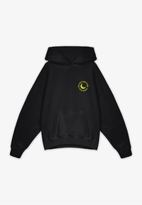 Zwarte hoodie met een kangoeroe-pockets. Heeft gele tekst "NIET STOREN" en een maansikkelfiguur op de voorkant.