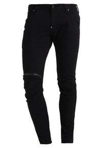 Svarta smala jeans tillverkade av ett stretchmaterial, med en dragkedjeficka och ribbade knädetaljer för en extra textur.