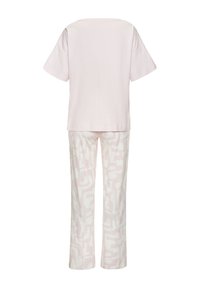Light pink cotton T-shirt with short sleeves paired with cream pants featuring an abstract, tonal pattern in pink.