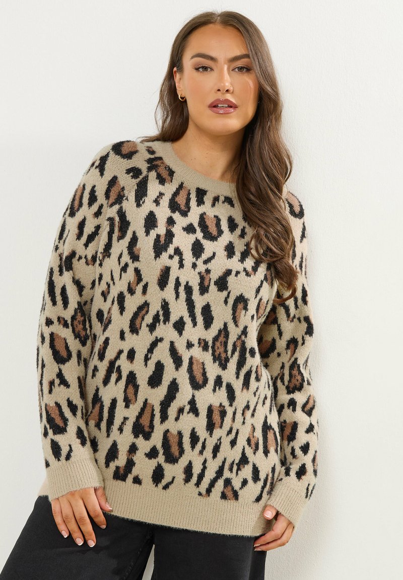 Beżowy sweter z wzorem w panterkę w kolorze czarnym i brązowym, z okrągłym dekoltem i długimi rękawami, wykonany z miękkiego materiału o fakturze.