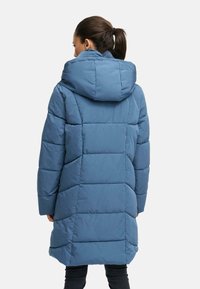 Padded blue hooded jacket with a seam design, featuring a relaxed fit and soft texture, suitable for cold weather.